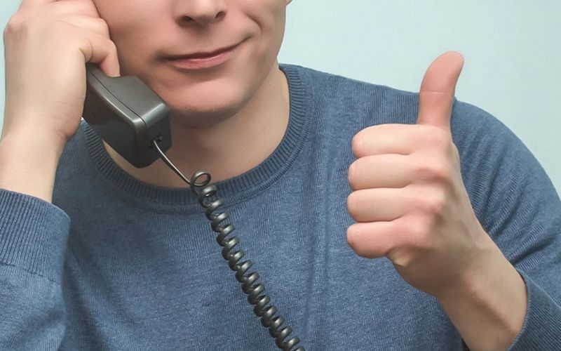 IT support technician on a call giving a thumbs up